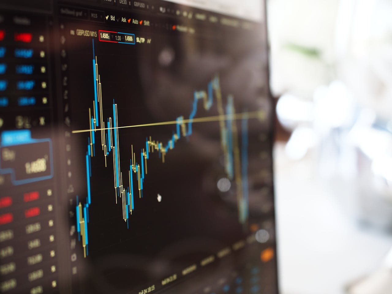 services-01 Detailed view of financial trading graphs on a monitor, illustrating stock market trends.